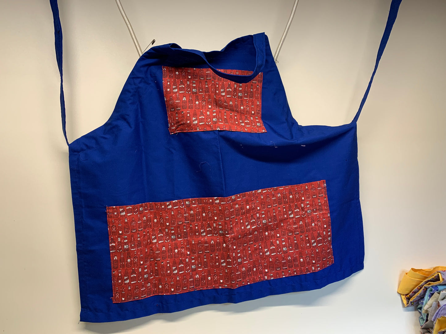 Full size Apron -Adjustable neckline. Blue with red pockets with hot sauce bottles