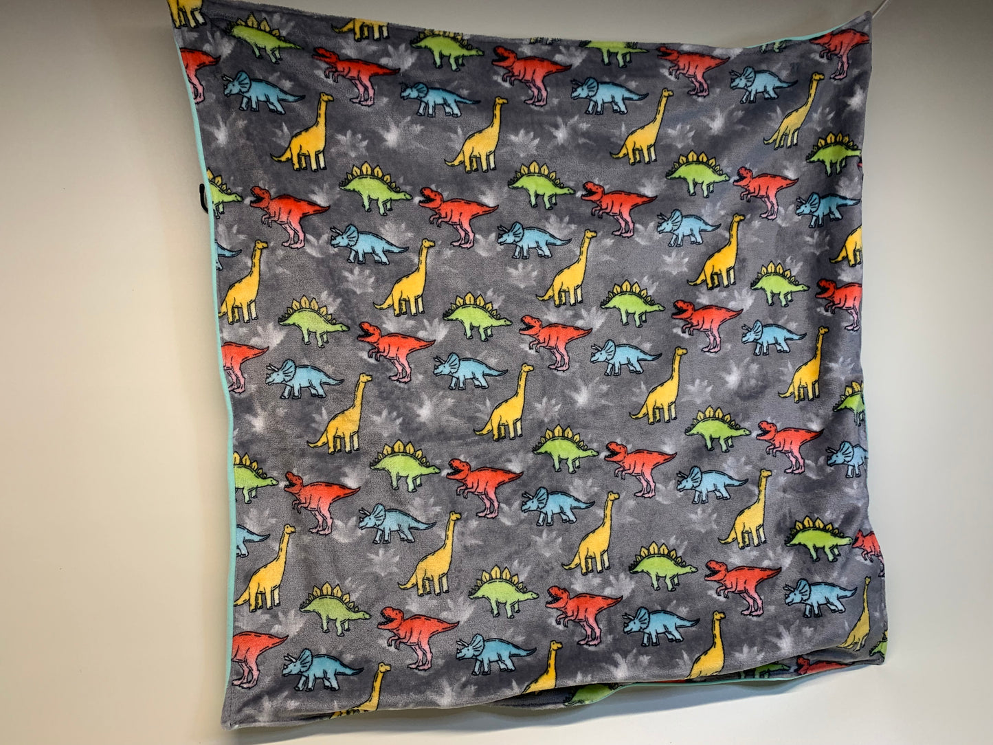 Baby Blanket - Side 1: teal blue with dinosaurs - Side 2: Grey with dinosaurs