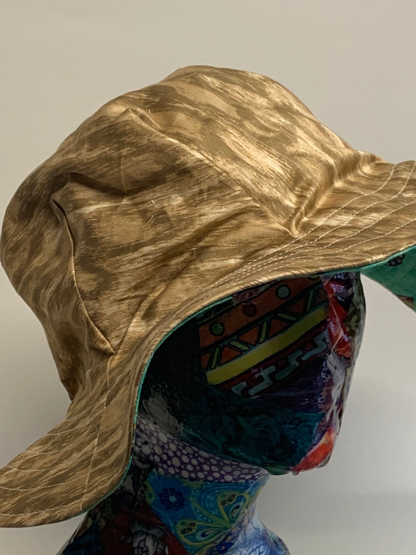 Bucket Hat - Reversable Designs - Gold color on side one - Teal with butterflies on the reverse