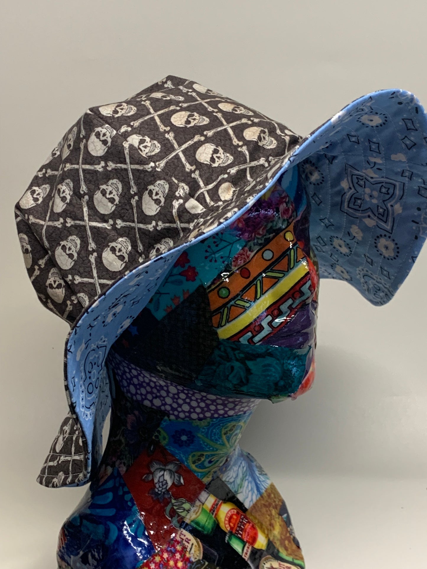 Bucket Hat - Reversable Designs - Blue Paisley on side one - Grey and white skull and crossbones on the reverse.