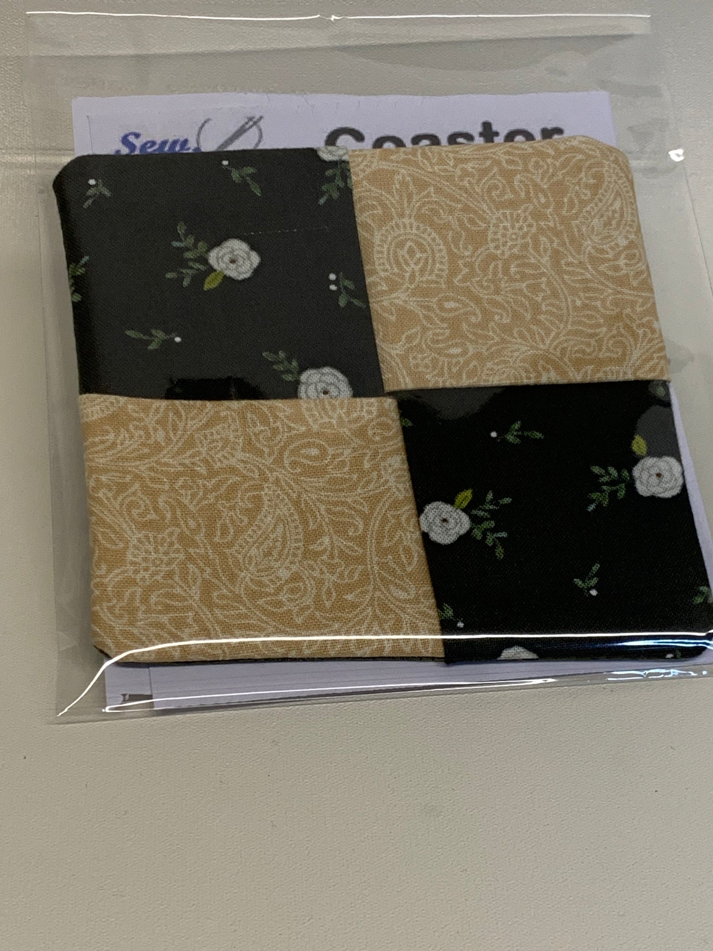 Coaster - black with white flowers and tan