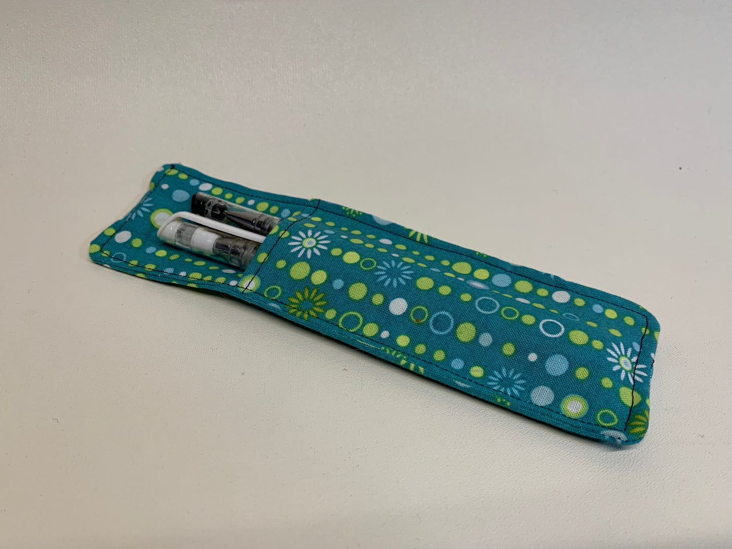 Pen Holder - holds two pens - Blue-green with white and yellow shapes - with elastic band