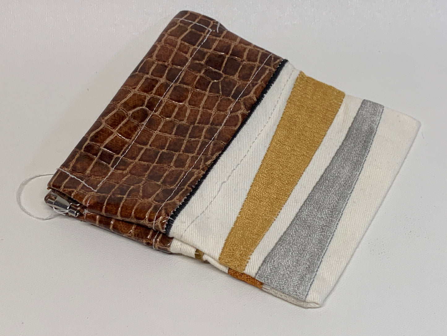 Unlined Pouch with Flex Frame Closure -  Brown vinyl top with White with tan and grey geometric fabric bottom- 4.5" x 5."