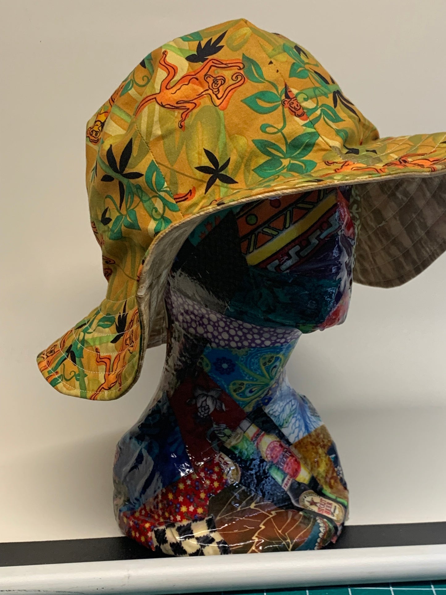 Bucket Hat  - Reversable Designs - Gold on side one - Tan with monkeys on the reverse