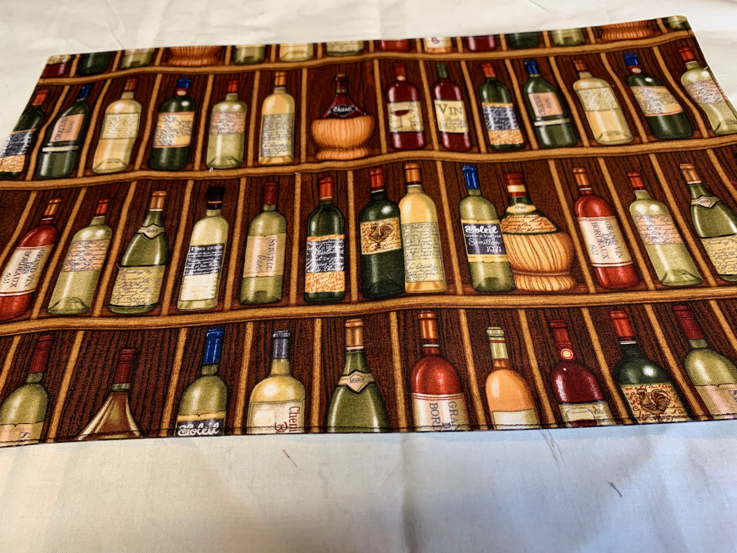 Placemat  - Wine bottles on one side and brown geometrics on the other side - 11 1/2" x 17"