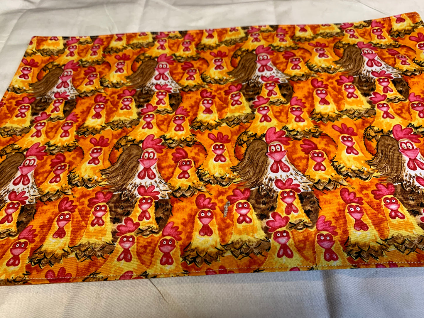 Placemat  - Chickens on one side and orange wood grain on the other side - 11 1/2" x 17"