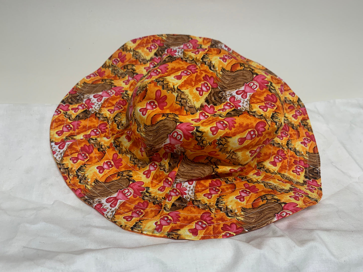 Bucket Hat  - Reversable Designs - Chickens on side one - Orange on the reverse.